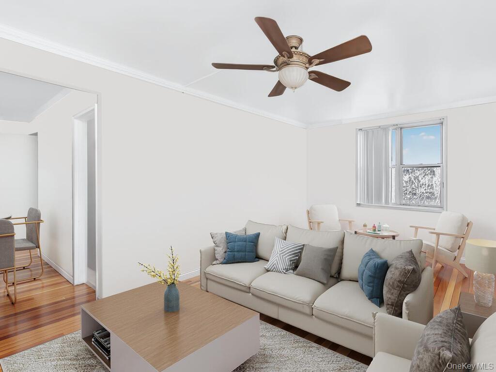 1475 Thieriot Avenue, Unit 5N Bronx, NY 10460 - Photo 10 of 22 a living room with furniture and a wooden floor