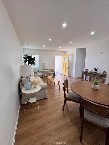 a living room with furniture a table and kitchen counter