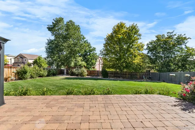 a backyard of a house with a tree