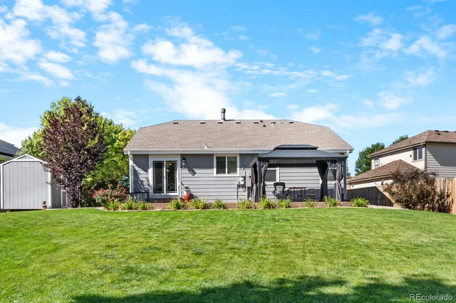 a view of a house with a tree in the background