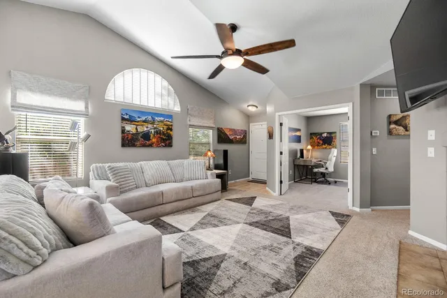 a living room with furniture and a large window