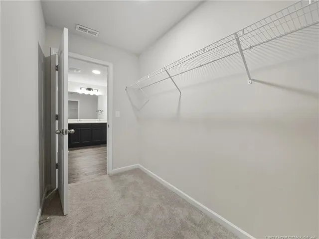 a view of a room with wooden floor and a bathroom