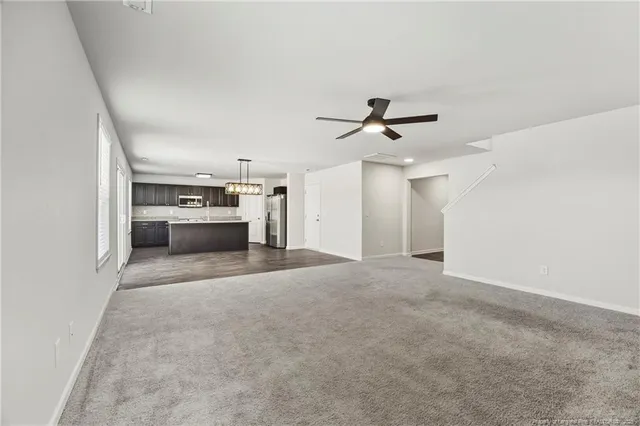 a view of a kitchen with a sink and a refrigerator