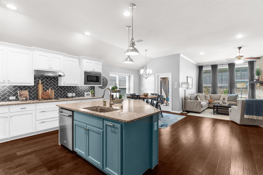 5604 Datewood Lane McKinney, TX 75071 - Photo 14 of 40 a kitchen with counter top space sink stove and wooden floor