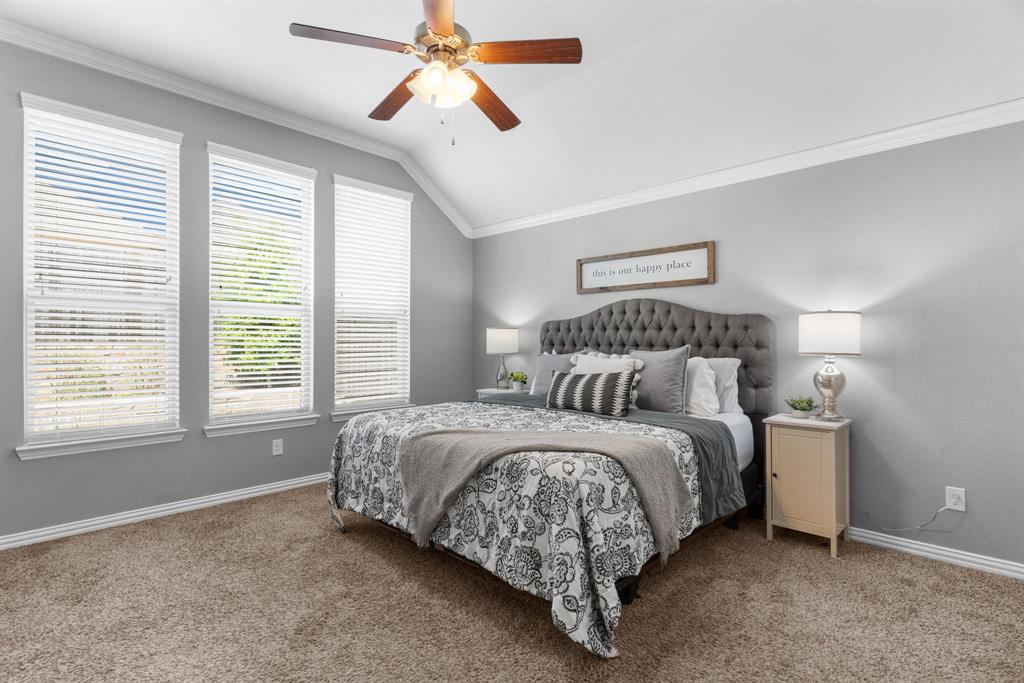 5604 Datewood Lane McKinney, TX 75071 - Photo 17 of 40 a bedroom with a bed and a chandelier