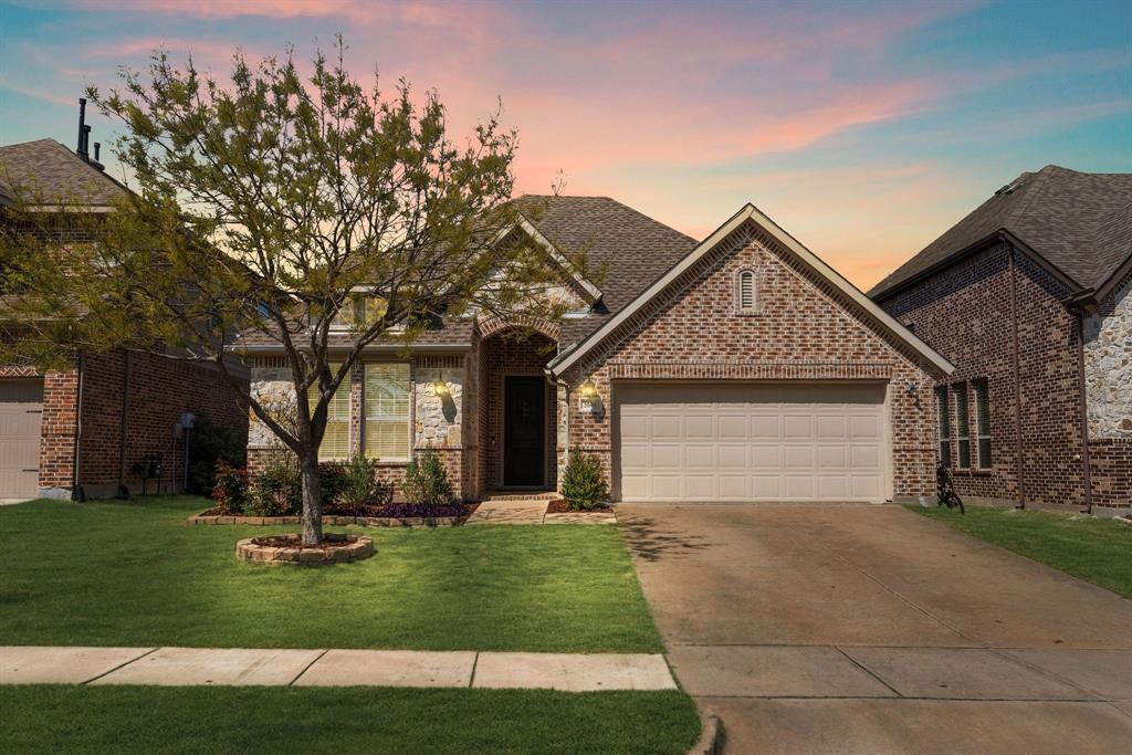 5604 Datewood Lane McKinney, TX 75071 - Photo 2 of 40 a front view of a house with a garden and trees