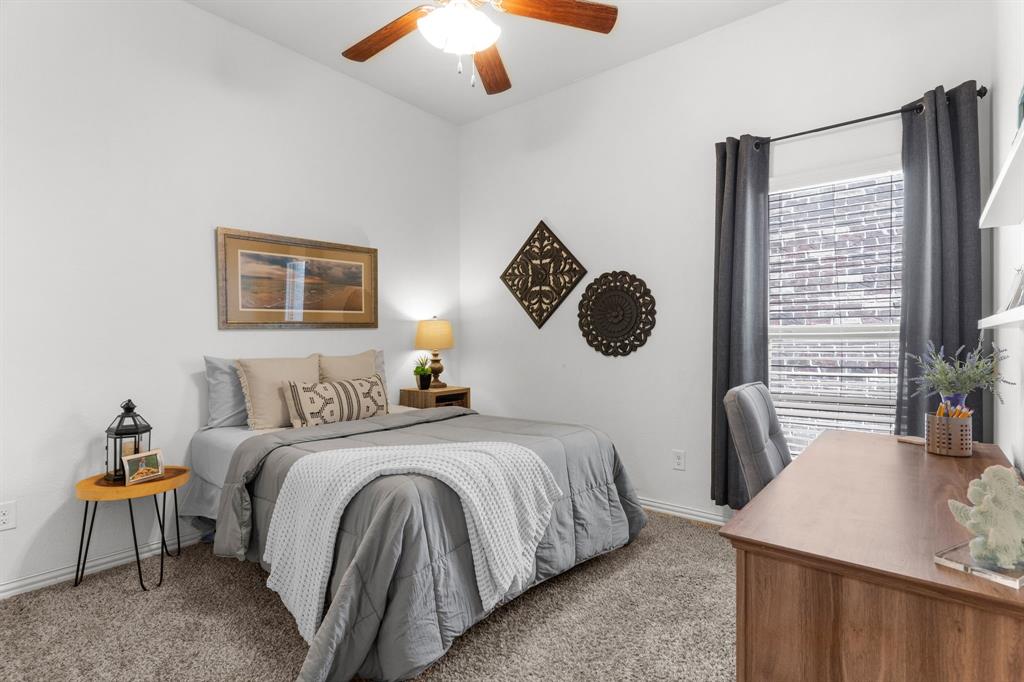 5604 Datewood Lane McKinney, TX 75071 - Photo 25 of 40 a bedroom with a bed and a chandelier