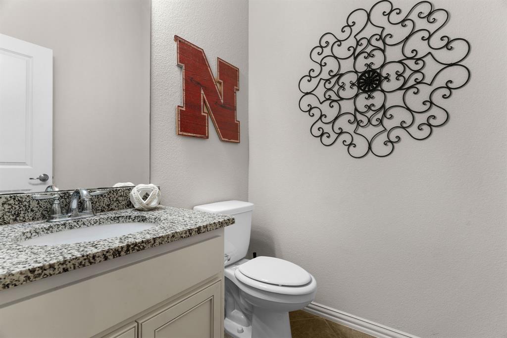 5604 Datewood Lane McKinney, TX 75071 - Photo 27 of 40 a bathroom with a granite countertop sink and a mirror