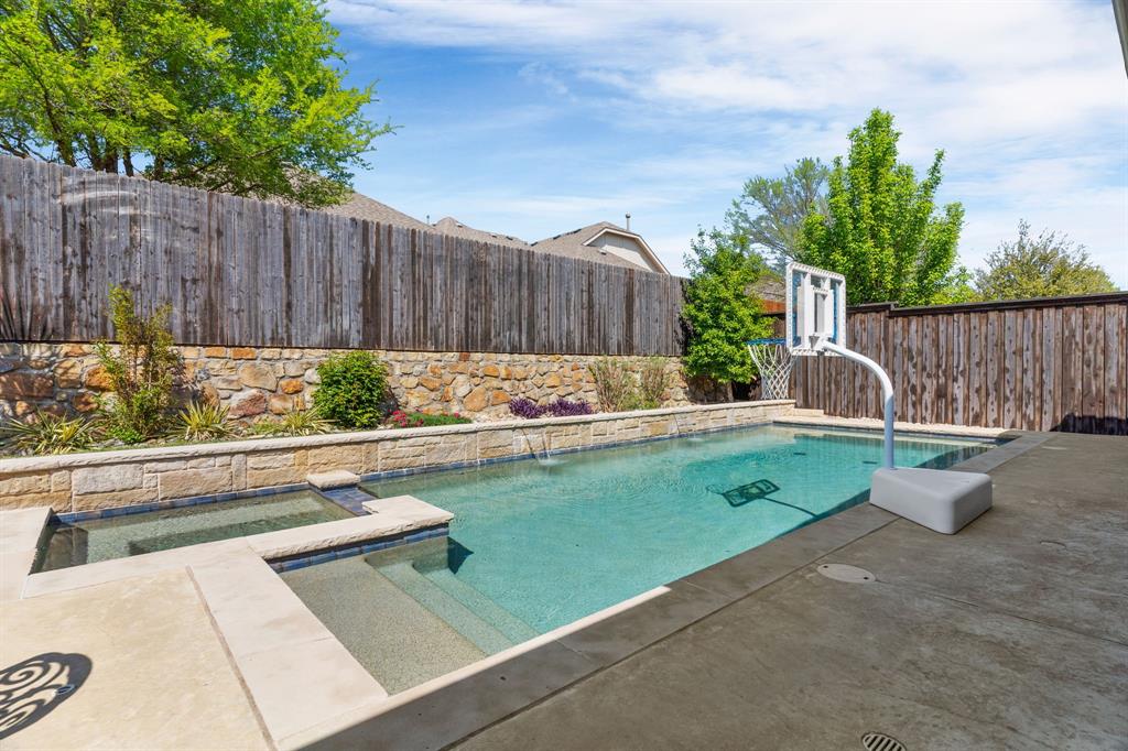 5604 Datewood Lane McKinney, TX 75071 - Photo 30 of 40 a view of a backyard with a small pool and a bench