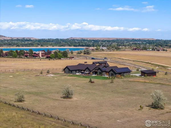 a living room with furniture a flat screen tv and a large window