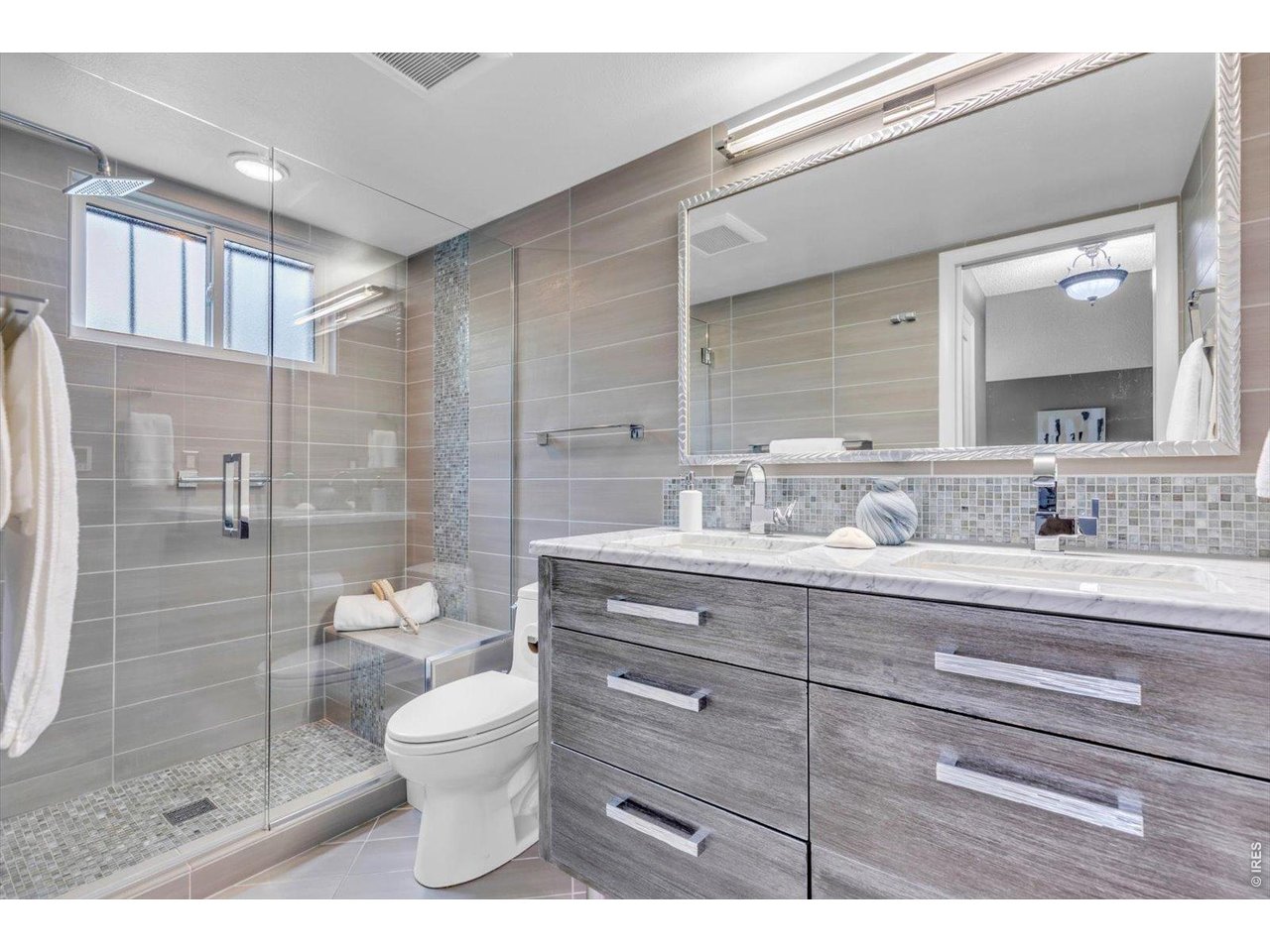 2423 Powderhorn Lane Boulder, CO 80305 - Photo 26 of 50 a bathroom with a toilet a sink a glass door a shower and a mirror