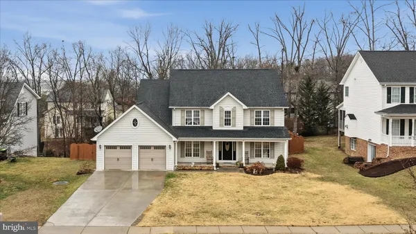 a front view of a house with yard porch and tree s