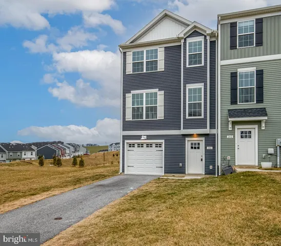 a front view of a house with a yard and balcony
