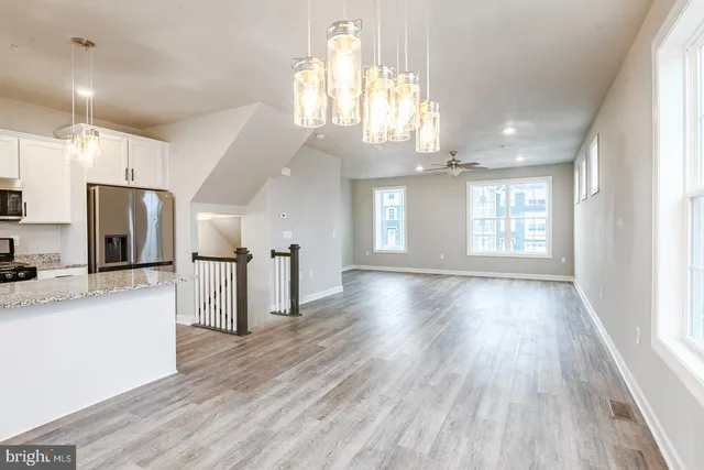 a view of a kitchen with a sink and a large window