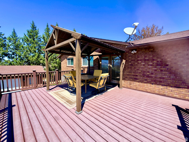12080 Mill Ridge Circle Sandy, UT 84094 - Photo 36 of 56 Expansive outdoor deck featuring wood-finish decking and a coordinating railing