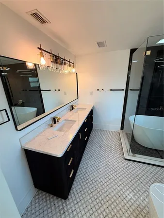 a bathroom with a sink a toilet and a mirror