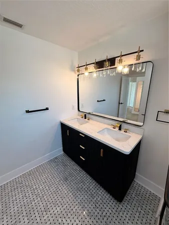 a bathroom with a sink vanity and mirror