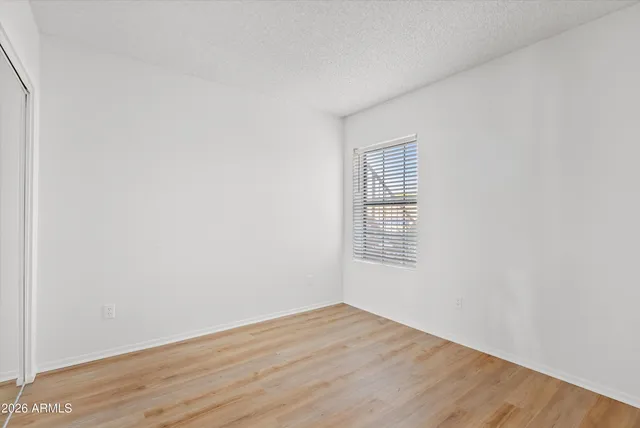 an empty room with wooden floor