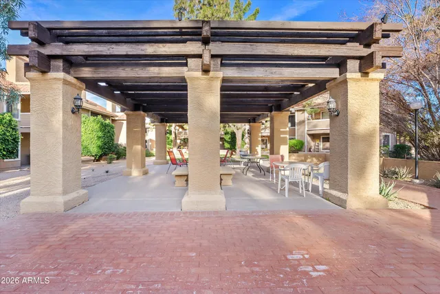 a front view of a house with a fountain