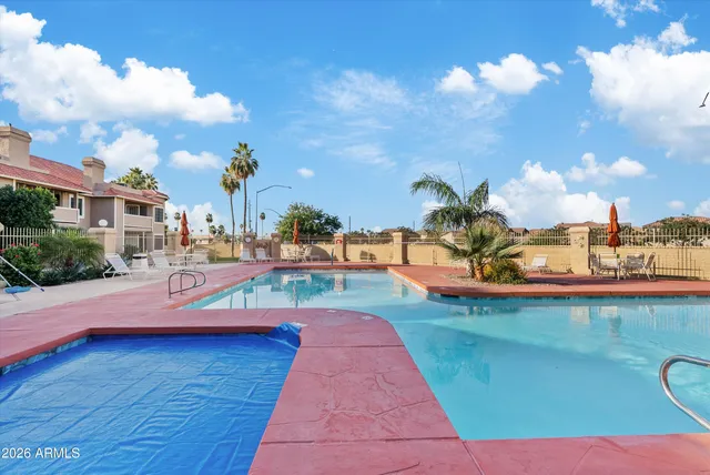 a view of a swimming pool and lounge chair