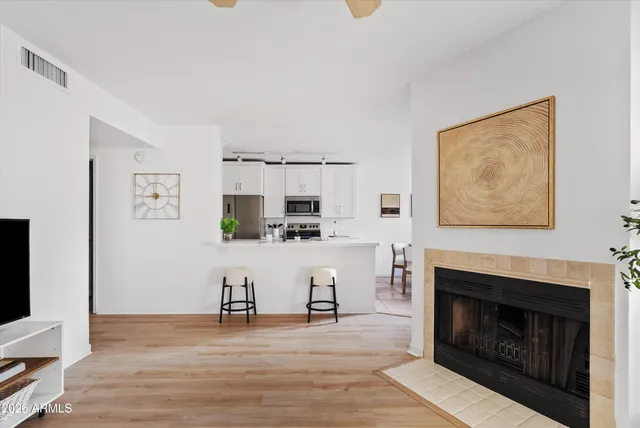 a living room with furniture a fireplace and a table
