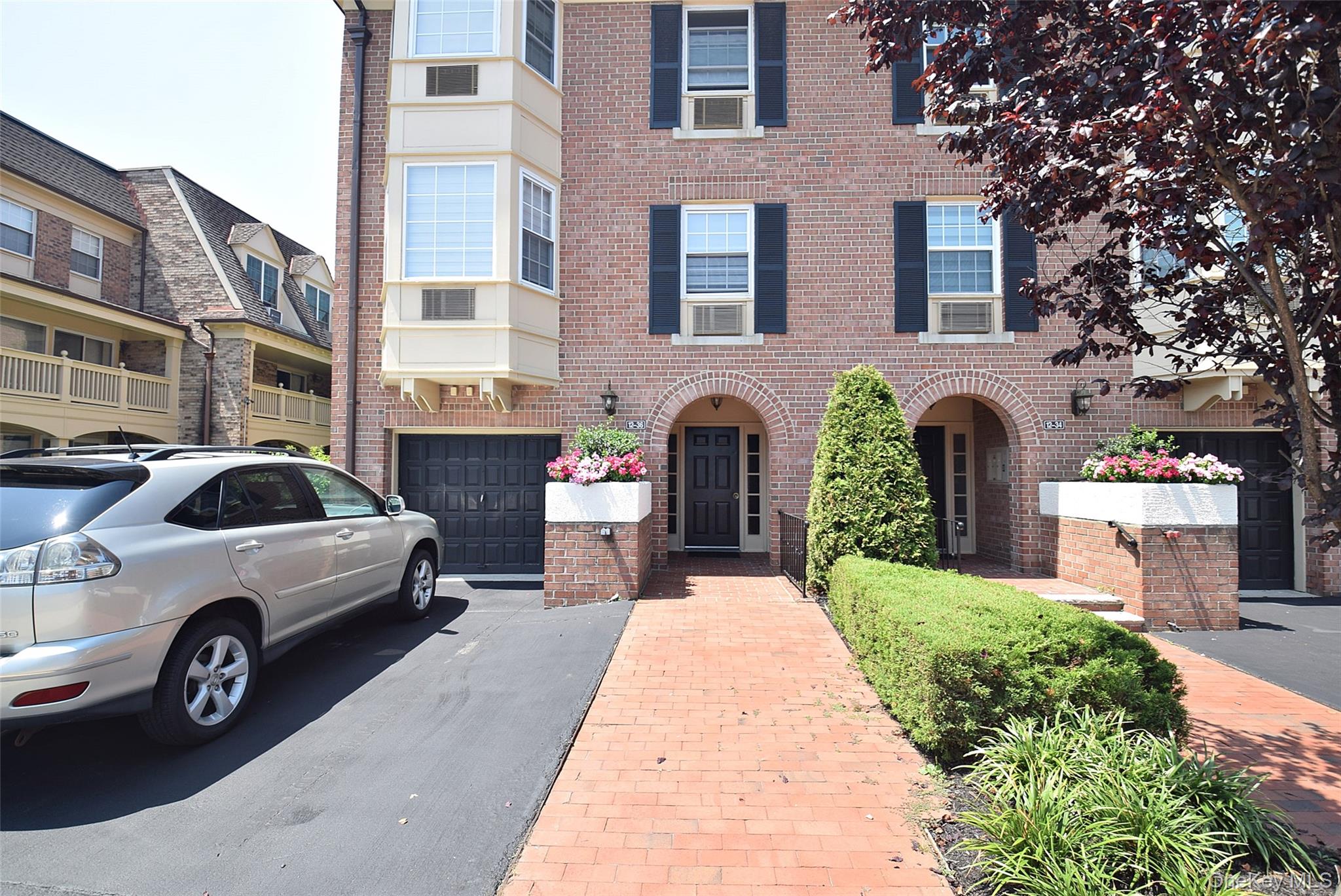 12-36 Estates Lane, Unit 49L Queens, NY 11360 - Photo 1 of 37 a view of a car parked in front of a brick building