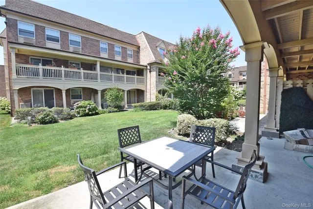 a view of a patio with table and chairs and potted plants
