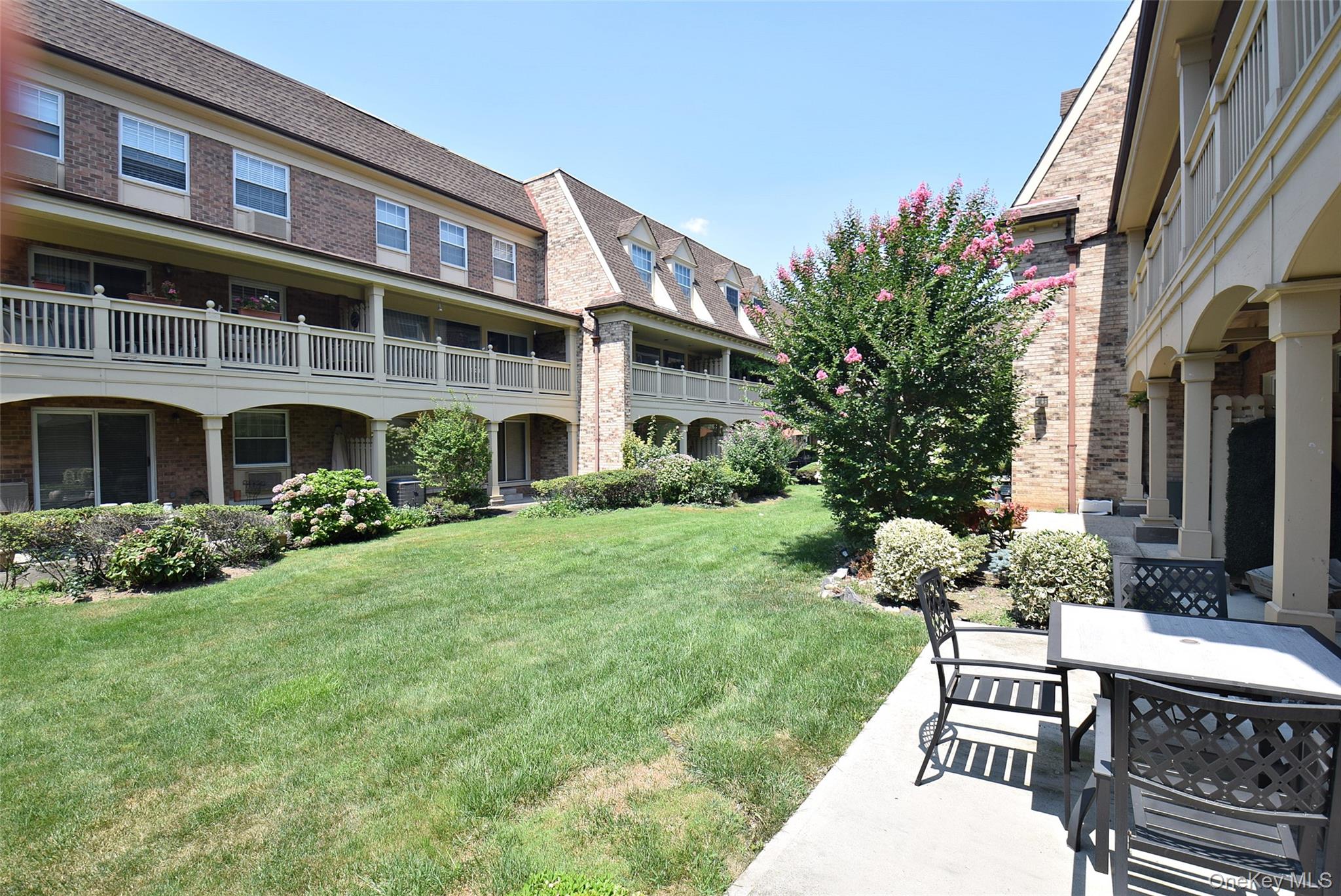 12-36 Estates Lane, Unit 49L Queens, NY 11360 - Photo 17 of 37 a house view with a garden space