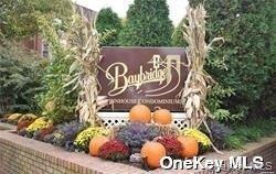 12-36 Estates Lane, Unit 49L Queens, NY 11360 - Photo 30 of 37 a street sign that is on a small yard