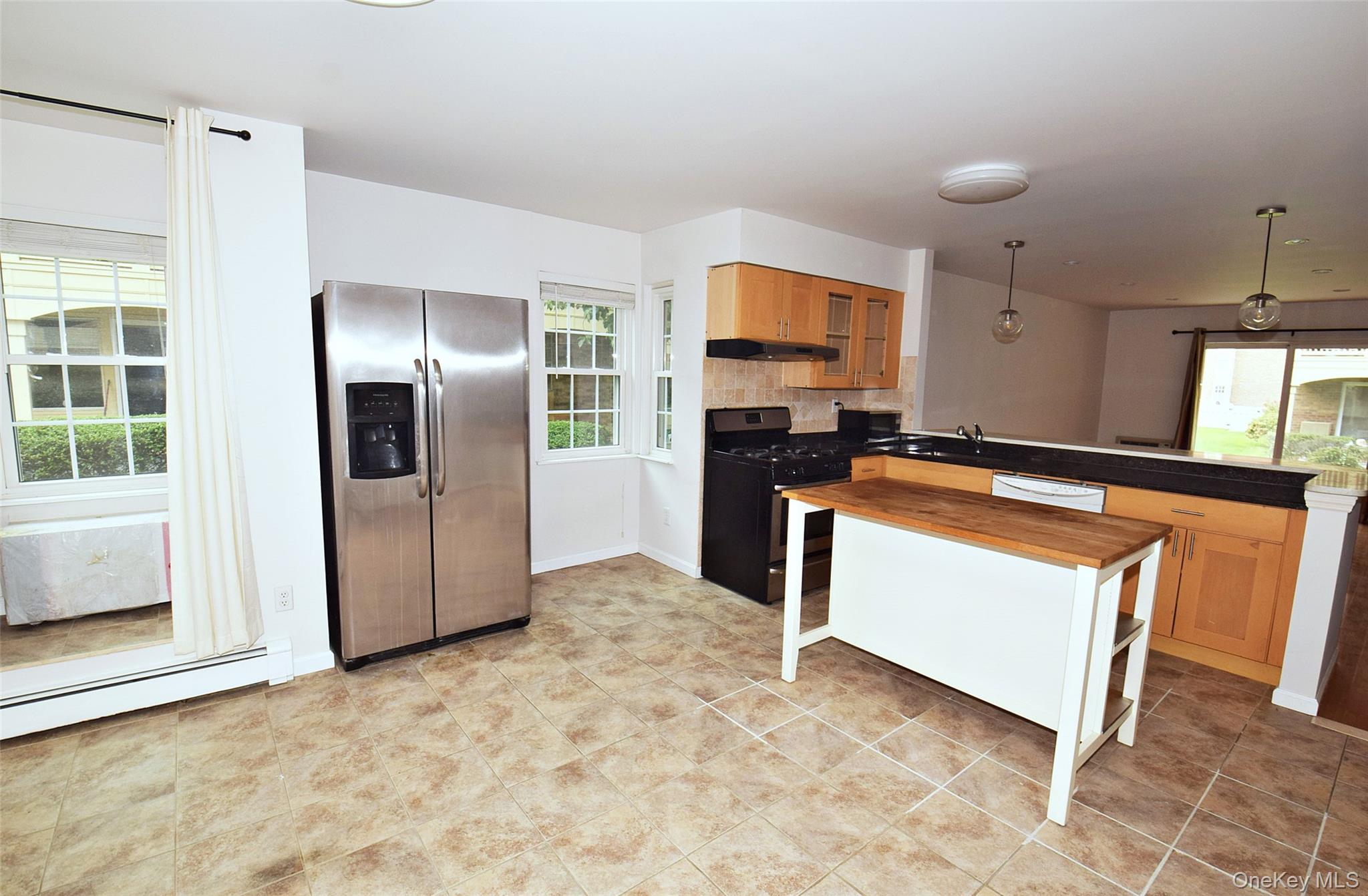12-36 Estates Lane, Unit 49L Queens, NY 11360 - Photo 36 of 37 a kitchen with stainless steel appliances granite countertop a refrigerator a stove and a sink