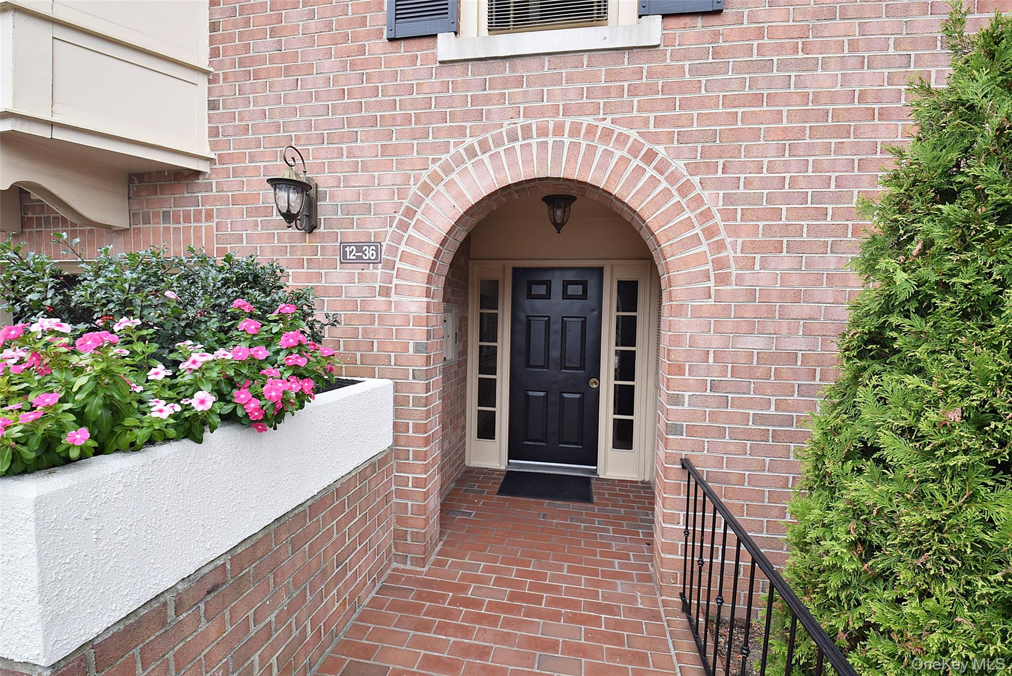 12-36 Estates Lane, Unit 49L Queens, NY 11360 - Photo 37 of 37 a view of entryway with flower pots