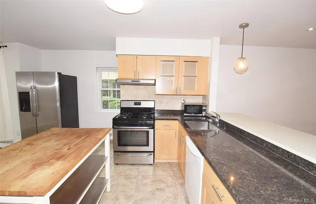 a kitchen with a stove and a refrigerator