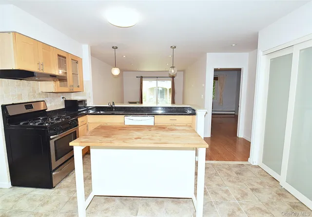 a kitchen with a stove and a sink