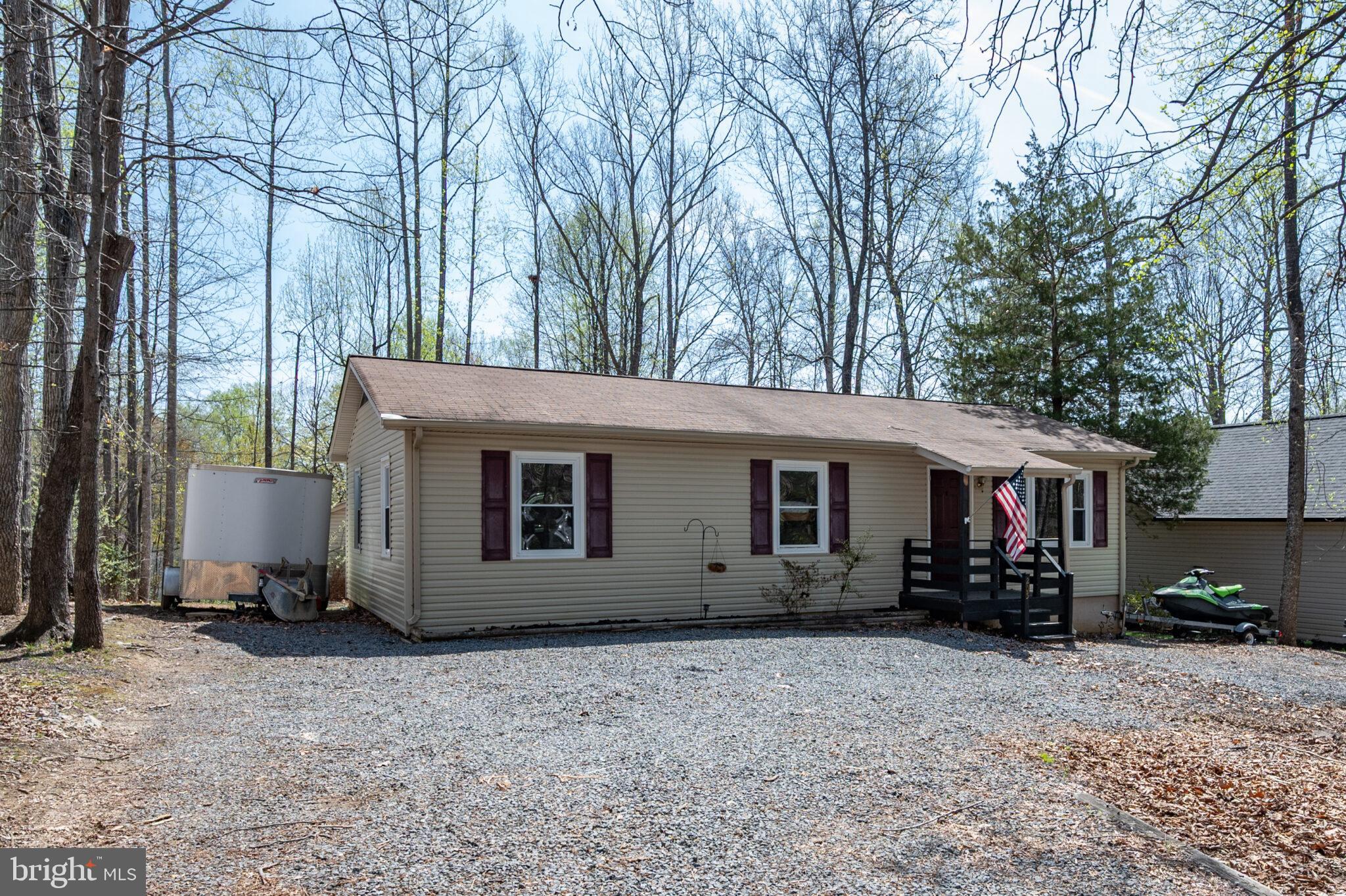 205 Monument Road Locust Grove, VA 22508 - Photo 1 of 49 a view of a house with a yard and large trees
