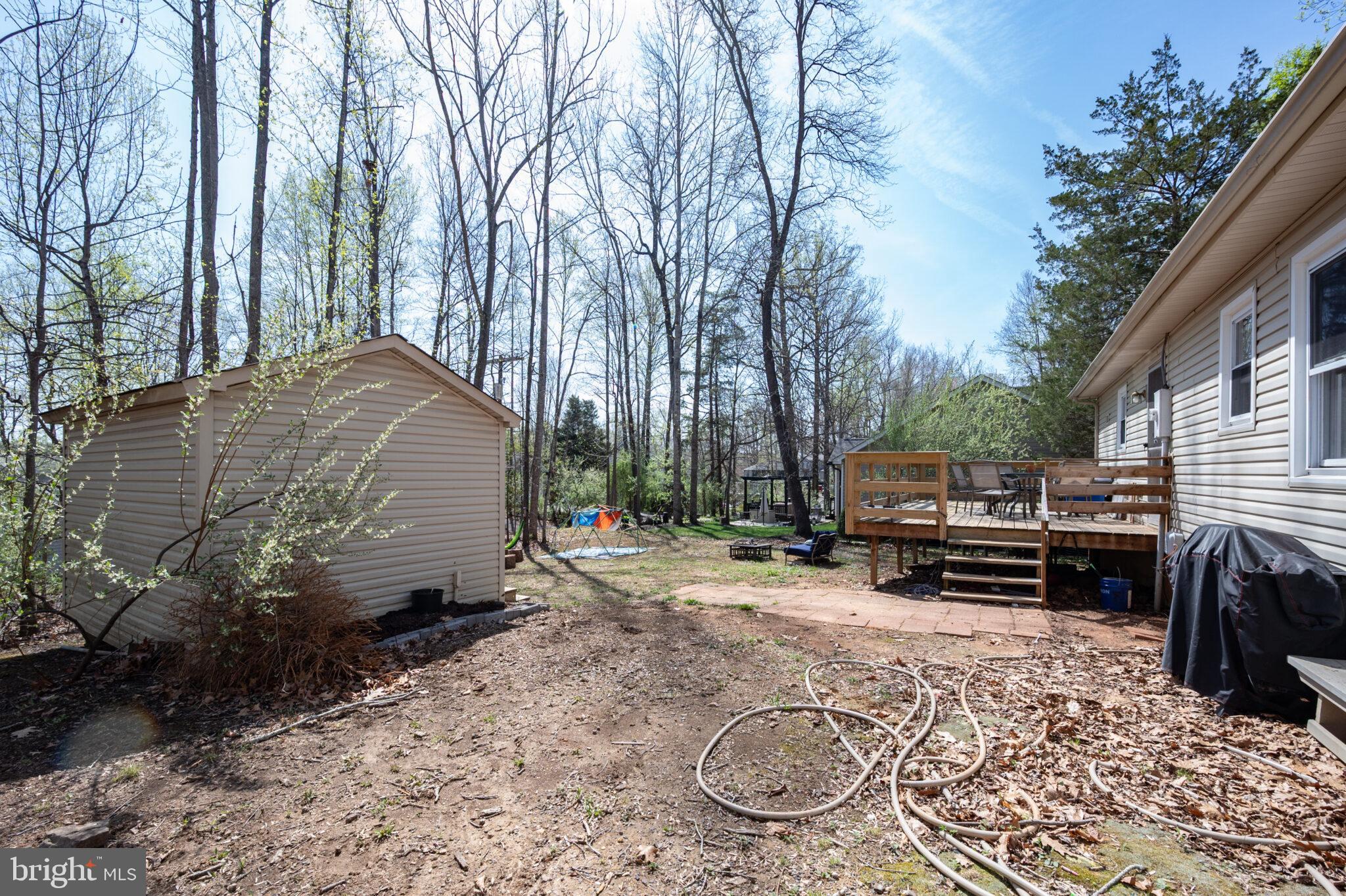 205 Monument Road Locust Grove, VA 22508 - Photo 29 of 49 a backyard of a house with barbeque oven and trees