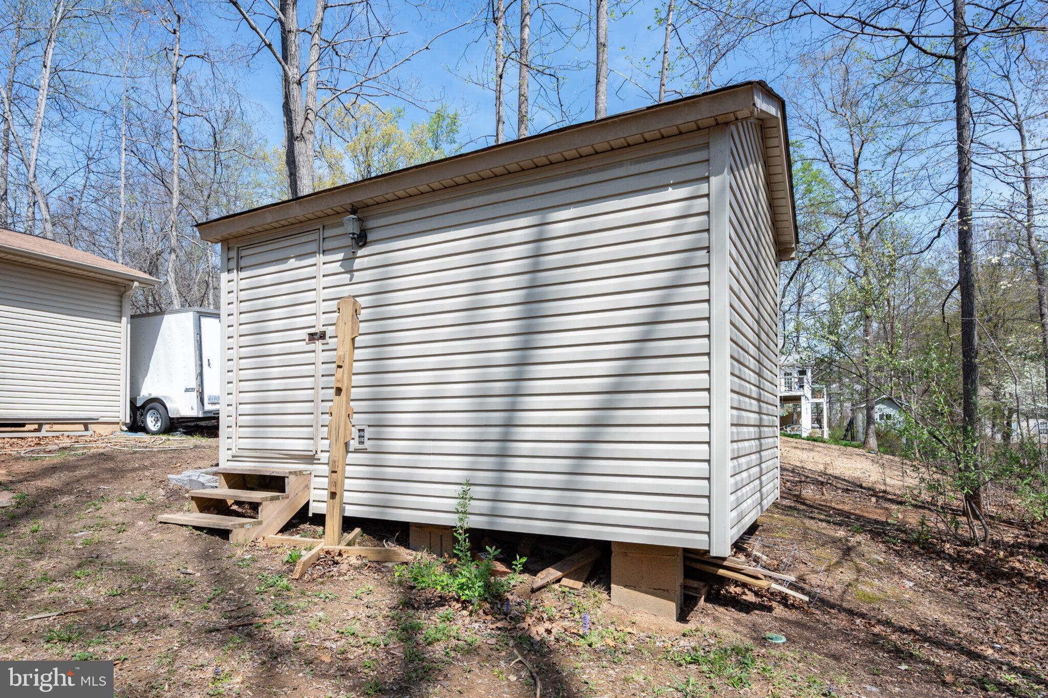 205 Monument Road Locust Grove, VA 22508 - Photo 31 of 49 a backyard of a house with wooden fence and large tree