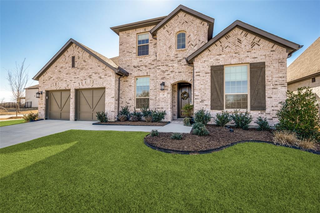 a view of a house with a yard and pathway