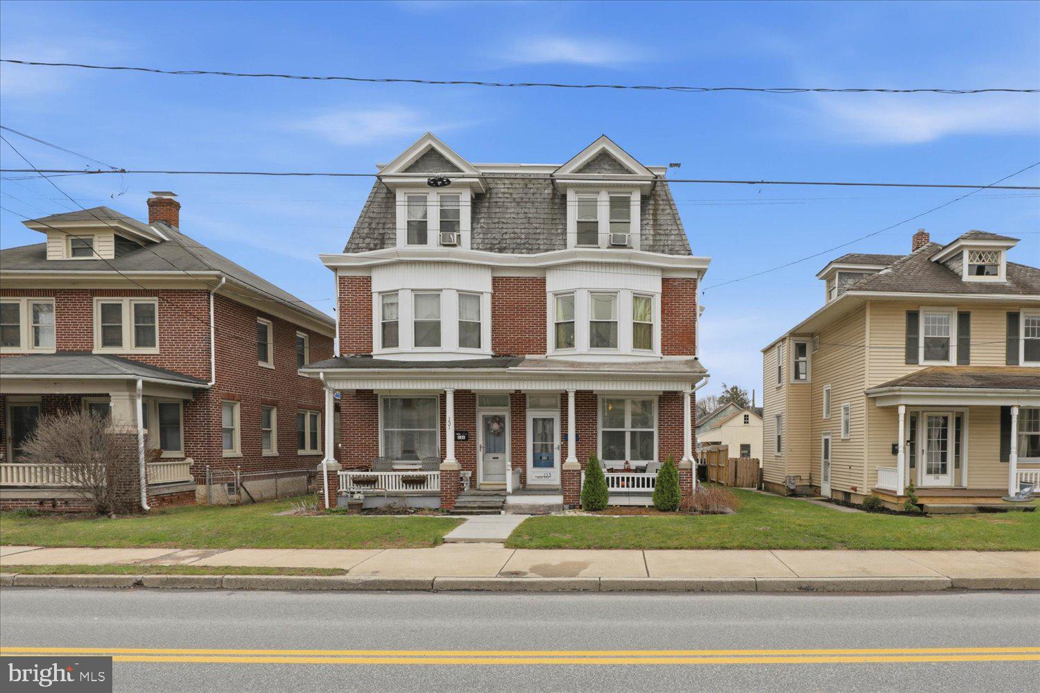 133 West High Street Manheim, PA 17545 - Photo 1 of 36 a front view of a residential apartment building with a yard