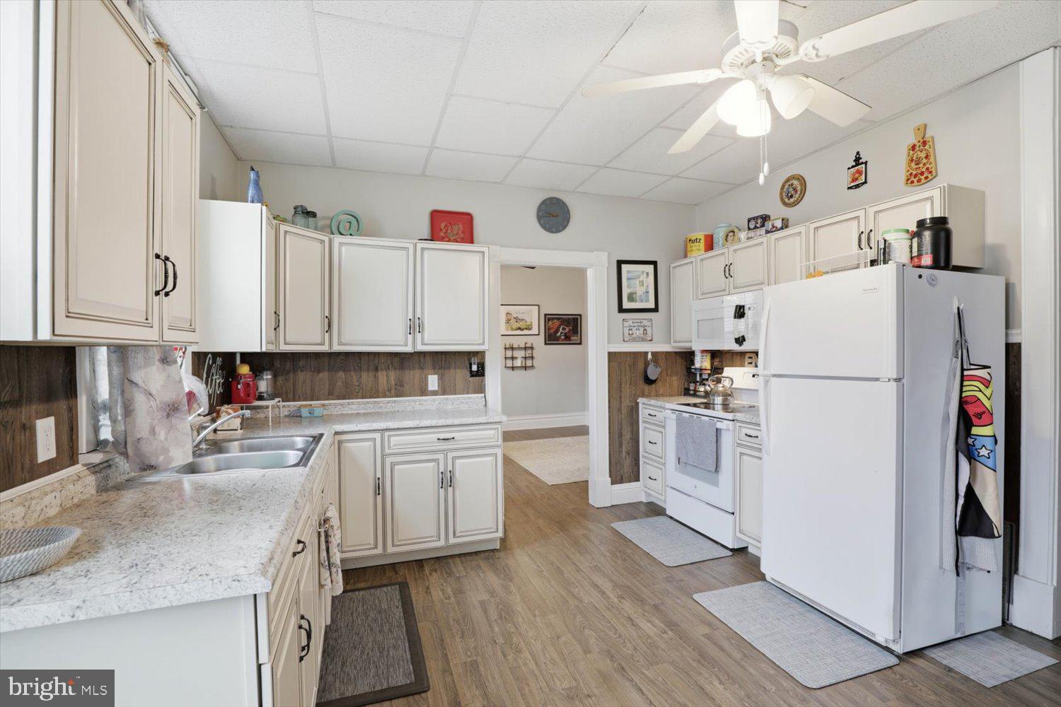 133 West High Street Manheim, PA 17545 - Photo 14 of 36 a kitchen with white cabinets and white appliances