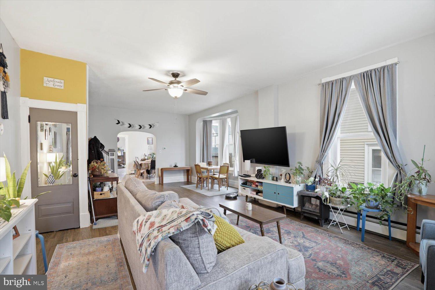 133 West High Street Manheim, PA 17545 - Photo 5 of 36 a living room with furniture a flat screen tv and a large window
