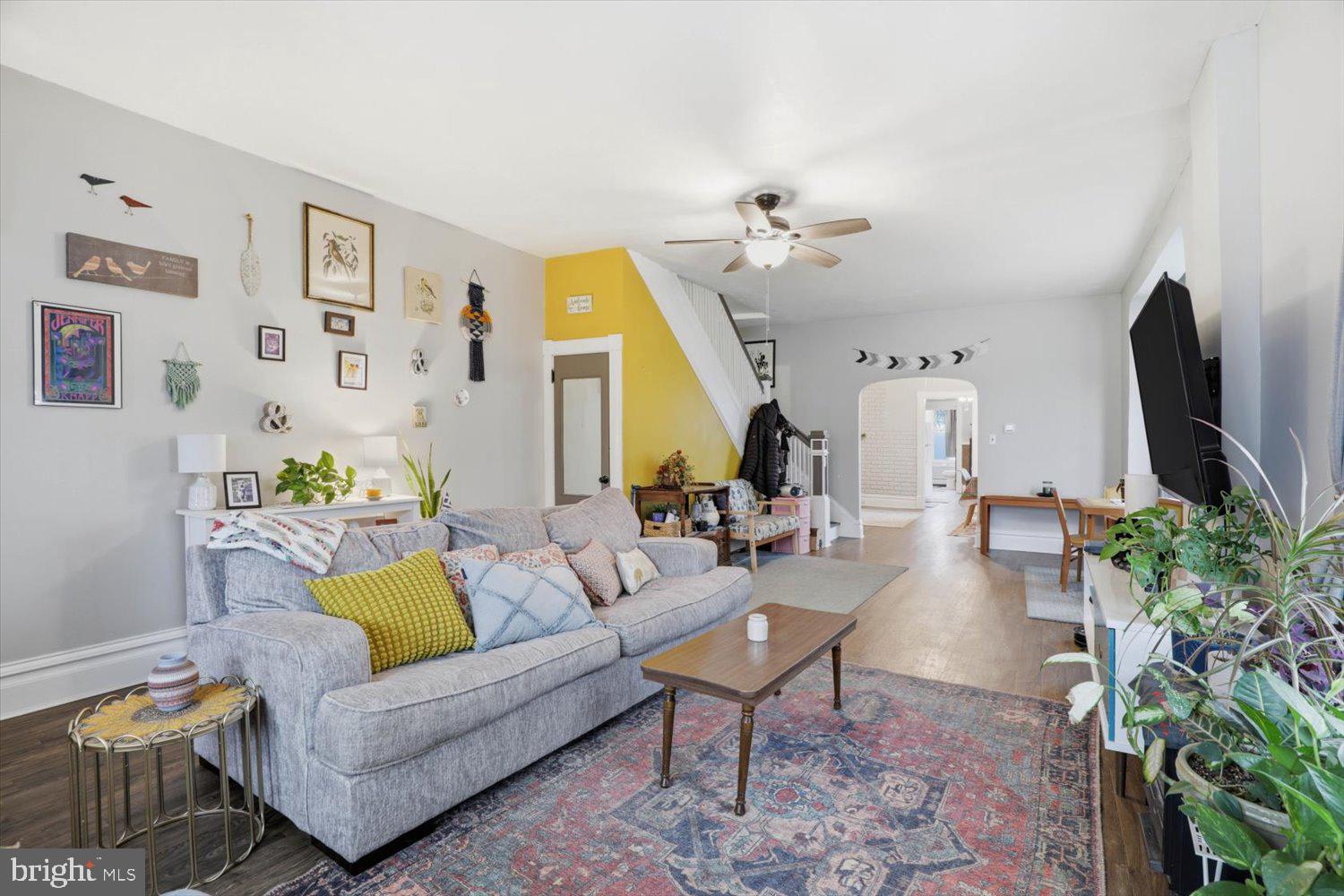 133 West High Street Manheim, PA 17545 - Photo 7 of 36 a living room with furniture a flat screen tv and a potted plant