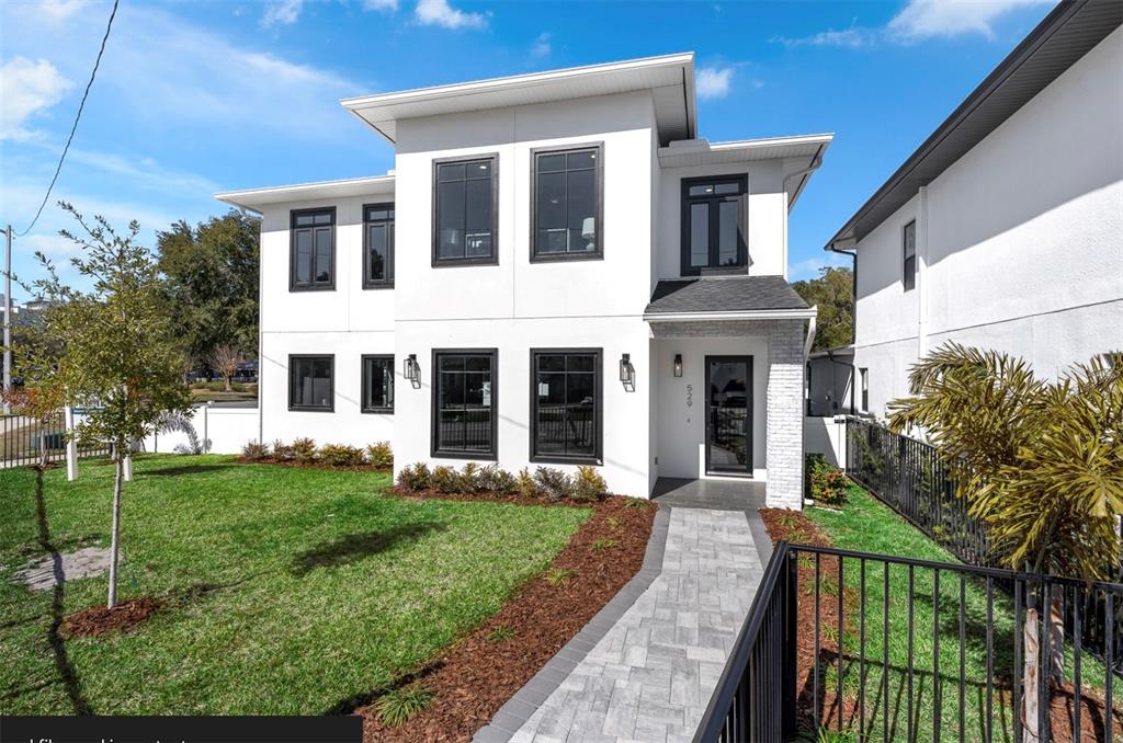 529 West Princeton Street Orlando, FL 32804 - Photo 1 of 50 a front view of a house with a yard