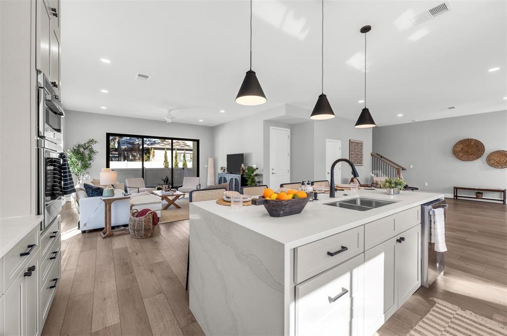 529 West Princeton Street Orlando, FL 32804 - Photo 12 of 50 a view of living room with kitchen island stainless steel appliances and wooden floor