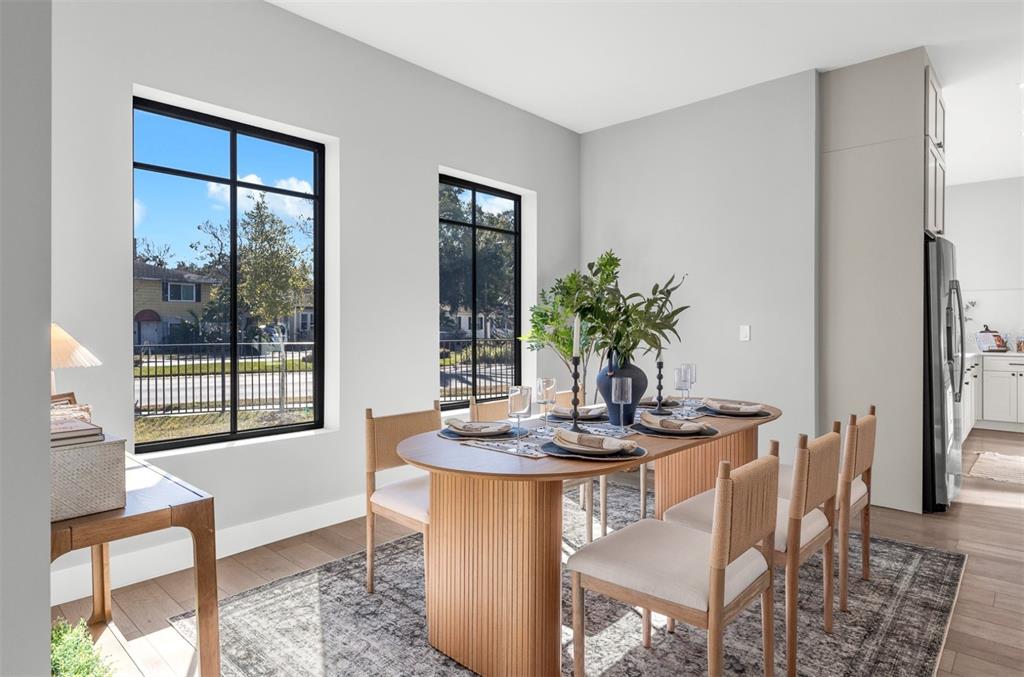 529 West Princeton Street Orlando, FL 32804 - Photo 19 of 50 a dining room with furniture potted plants and wooden floor