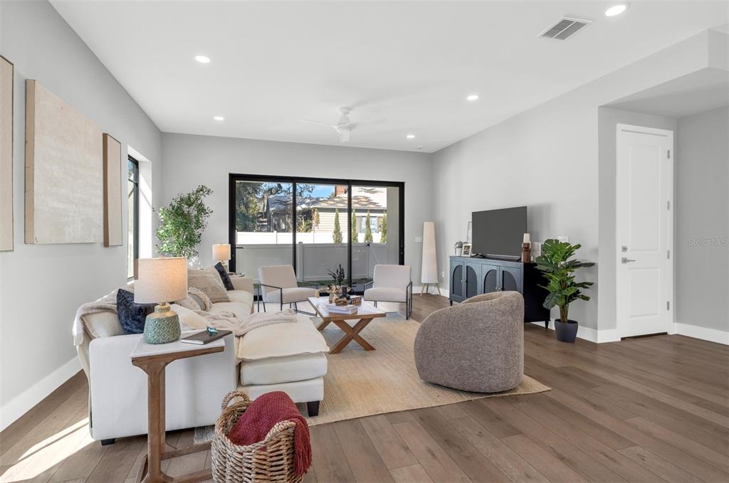 529 West Princeton Street Orlando, FL 32804 - Photo 21 of 50 a living room with fireplace furniture and a potted plant