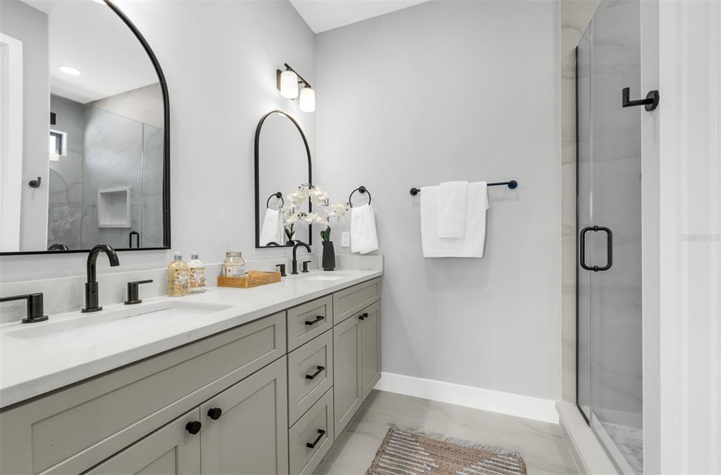 529 West Princeton Street Orlando, FL 32804 - Photo 36 of 50 a bathroom with a double vanity sink and mirror