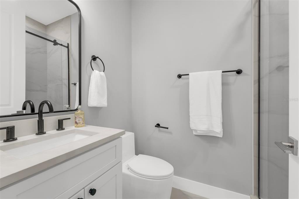 529 West Princeton Street Orlando, FL 32804 - Photo 37 of 50 a bathroom with a toilet sink and mirror