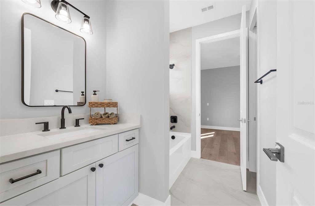 529 West Princeton Street Orlando, FL 32804 - Photo 39 of 50 a en suite bathroom with a double vanity sink mirror and