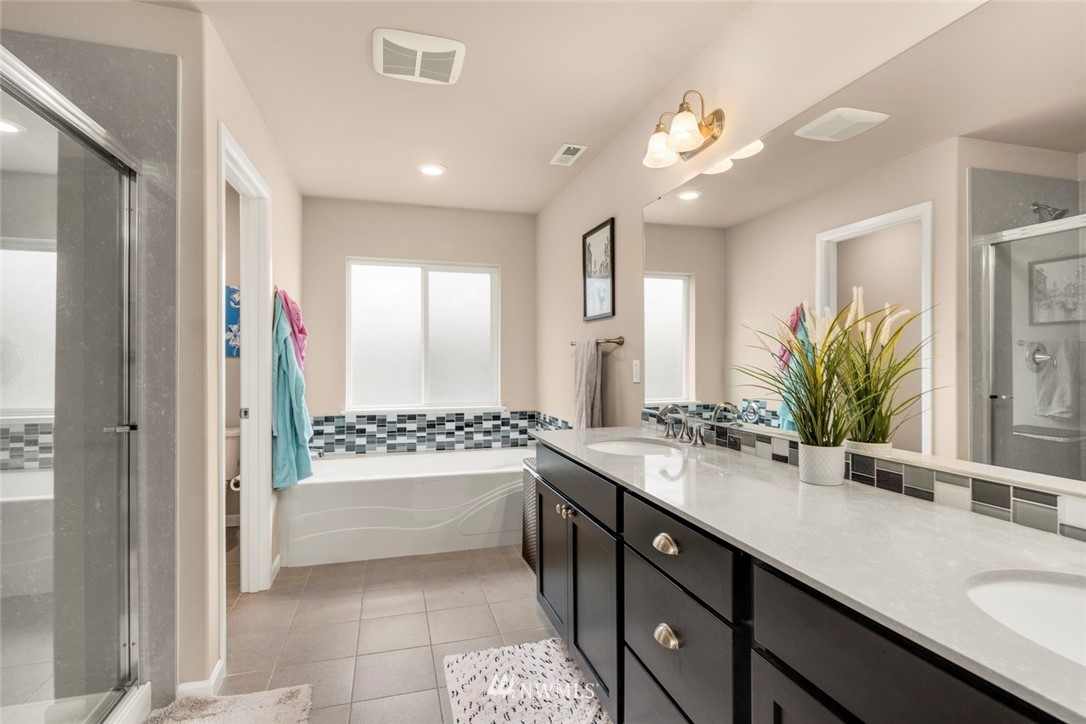 3 159th Place Southeast Bothell, WA 98012 - Photo 14 of 27 a bathroom with a sink a large mirror and a bathtub