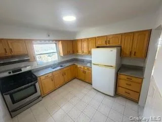 a kitchen with a refrigerator and a stove top oven